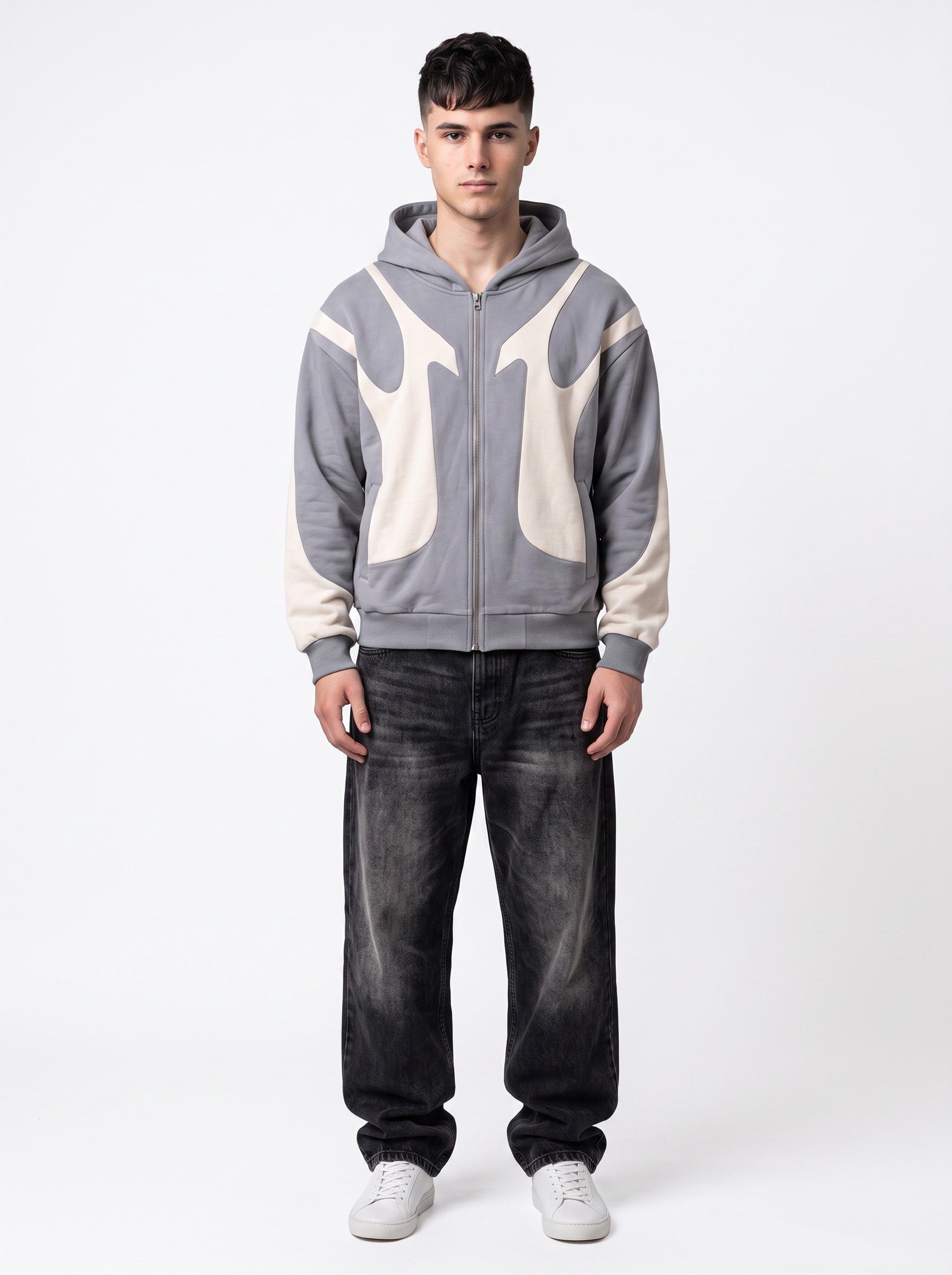 Model wearing Y2K Studio grey and cream flame panel zip-up hoodie paired with black baggy jeans