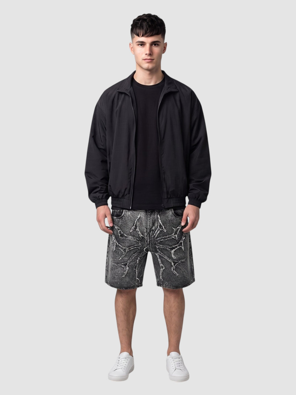 Y2K Studio acid wash denim jorts featuring thorny star applique and raw frayed hems worn by a male model