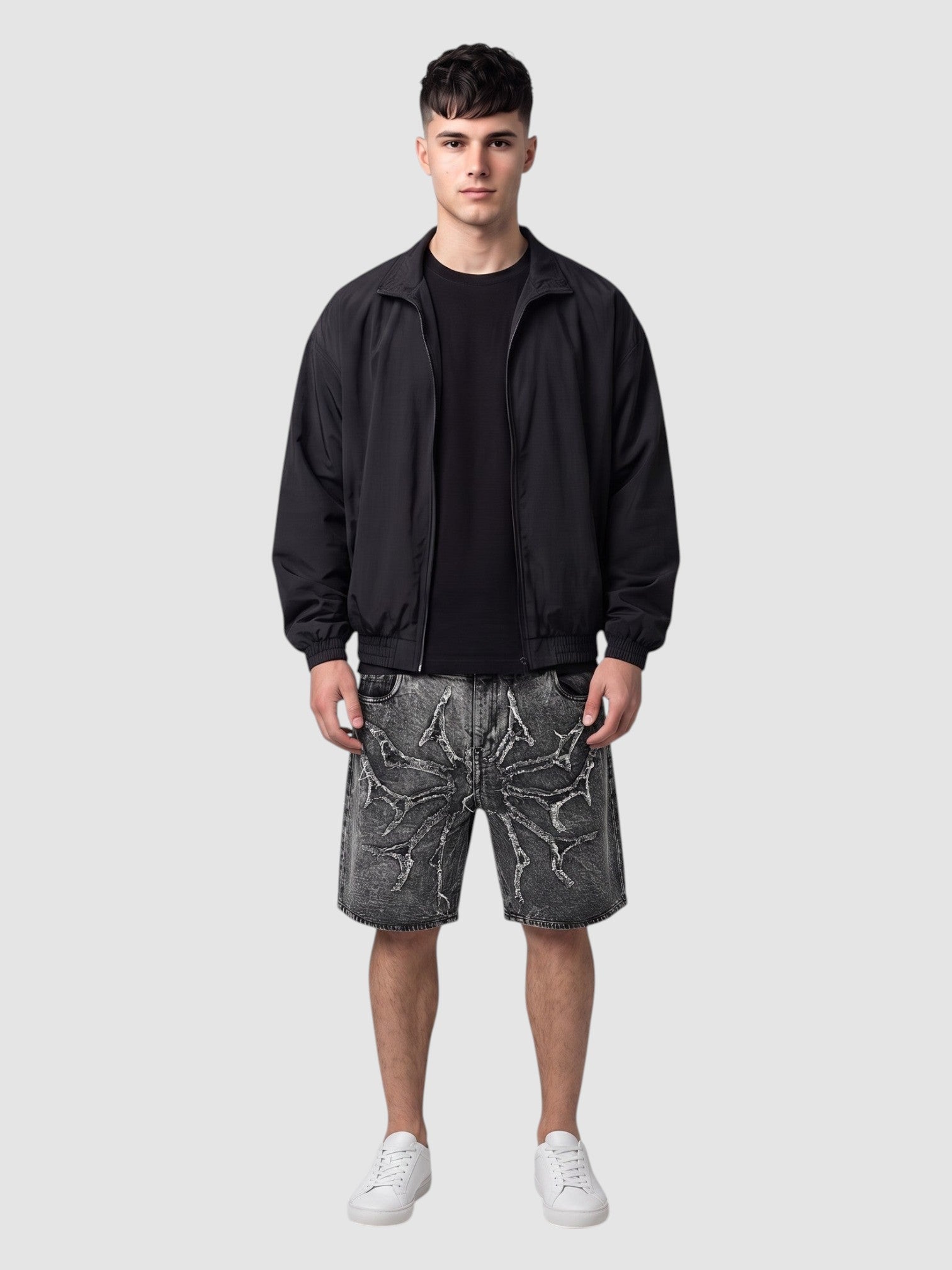 Y2K Studio acid wash denim jorts featuring thorny star applique and raw frayed hems worn by a male model