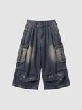 Y2K Studio baggy cargo denim shorts in a faded blue wash with large side pockets and a high-waisted pleated fit.