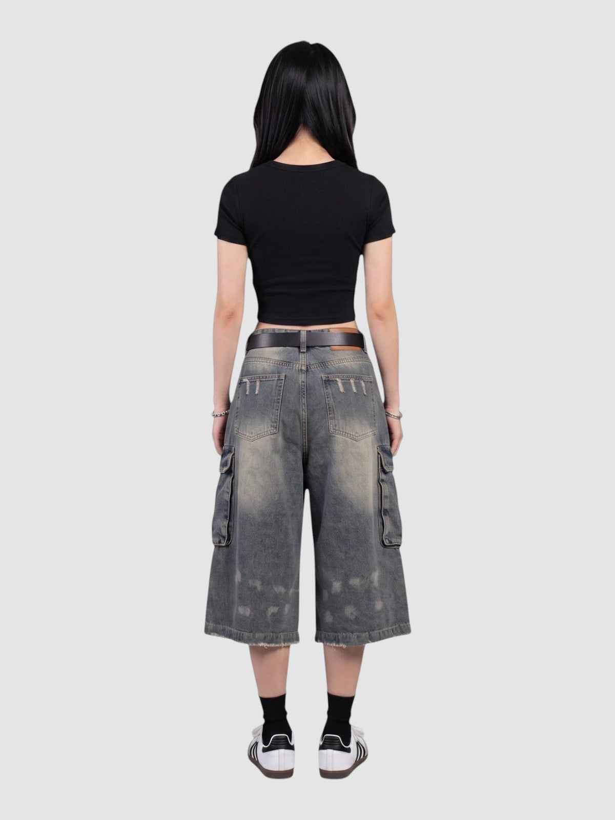 Y2K Studio baggy denim cargo shorts with a distressed wash, side pockets, and high-waisted fit, back view.