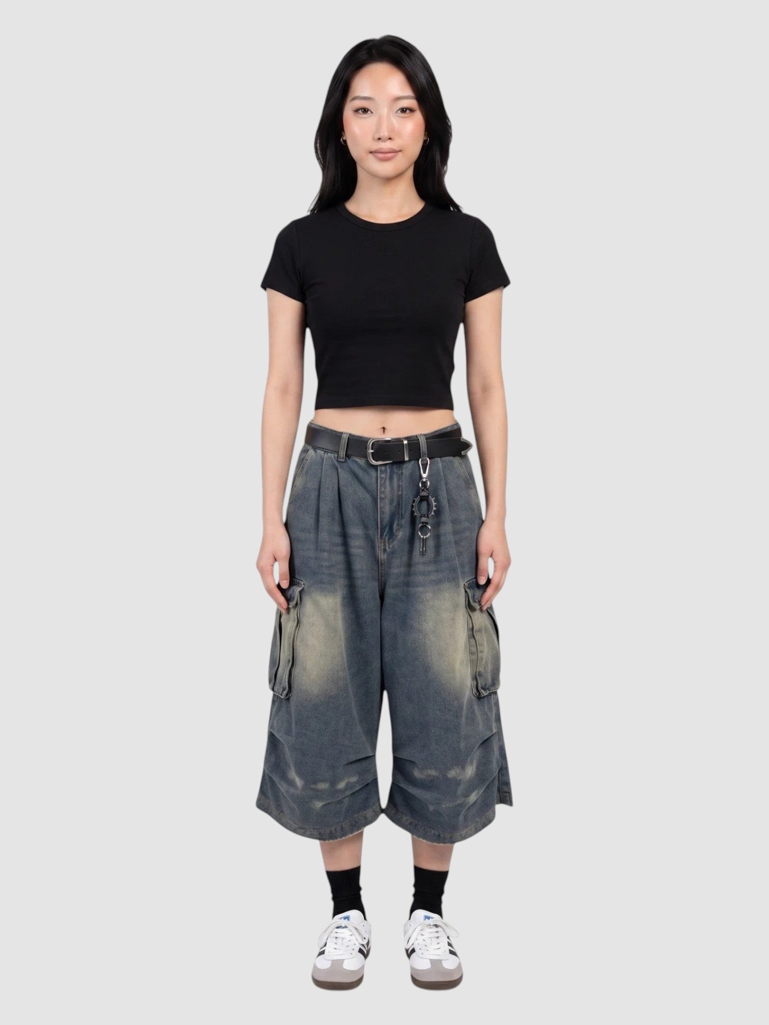 Y2K Studio baggy denim cargo shorts with a high-waisted, wide-leg fit, featuring side flap pockets and faded wash.