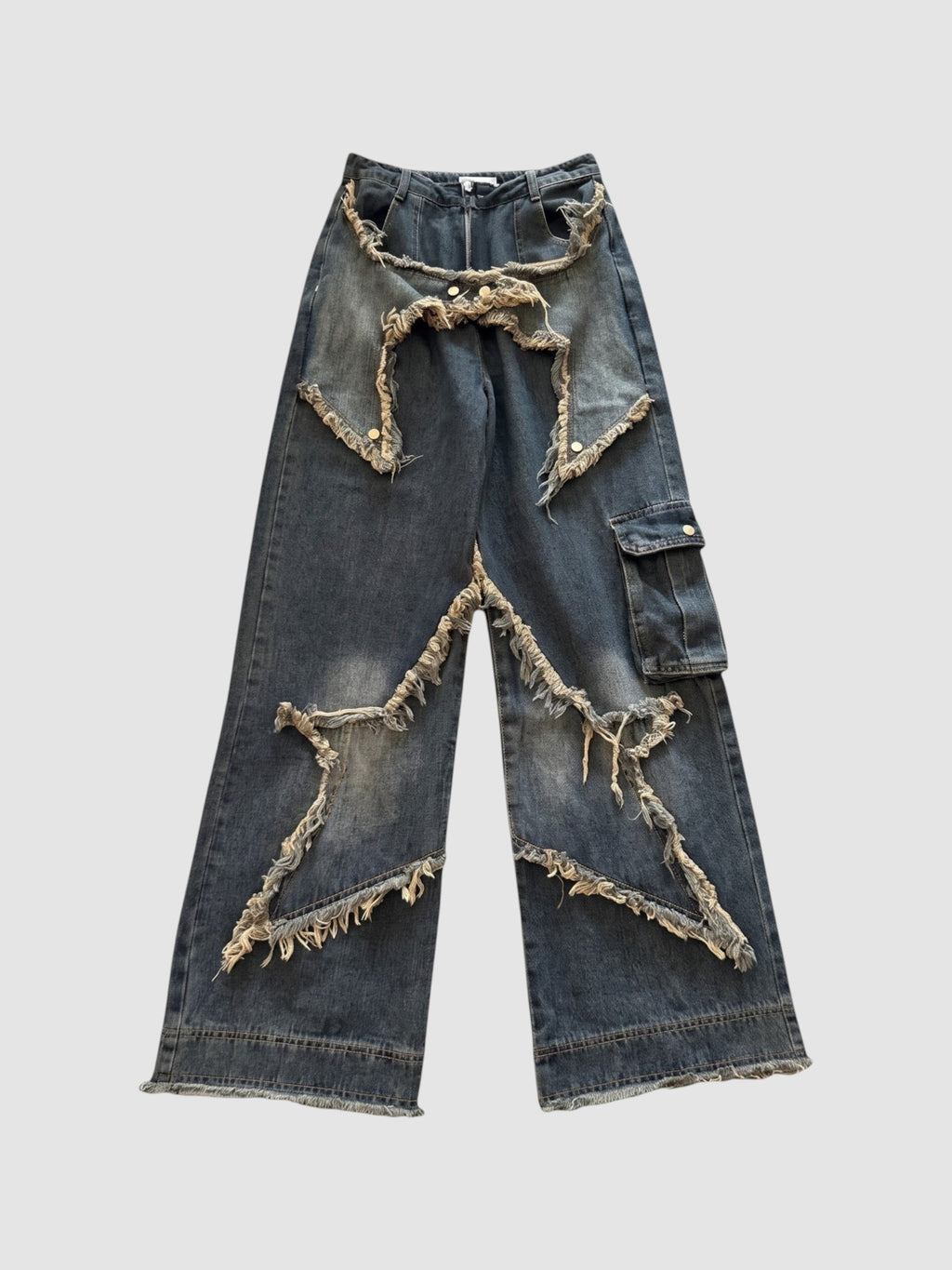 Y2K Studio high-waisted baggy cargo jeans in indigo denim with frayed star-shaped patchwork and side cargo pocket.