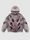 Y2K Studio oversized beige hoodie with patchwork eye cutouts, blue pupils, and red relief stitching details.