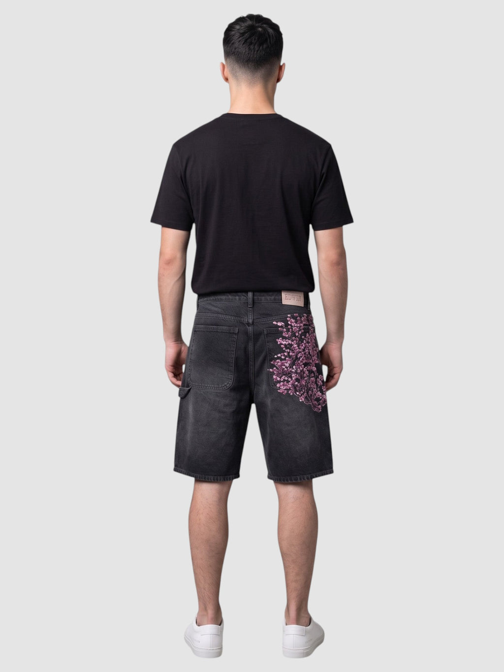 Y2K STUDIO black denim jorts with pink and white embroidered cherry blossom branch on the back pocket