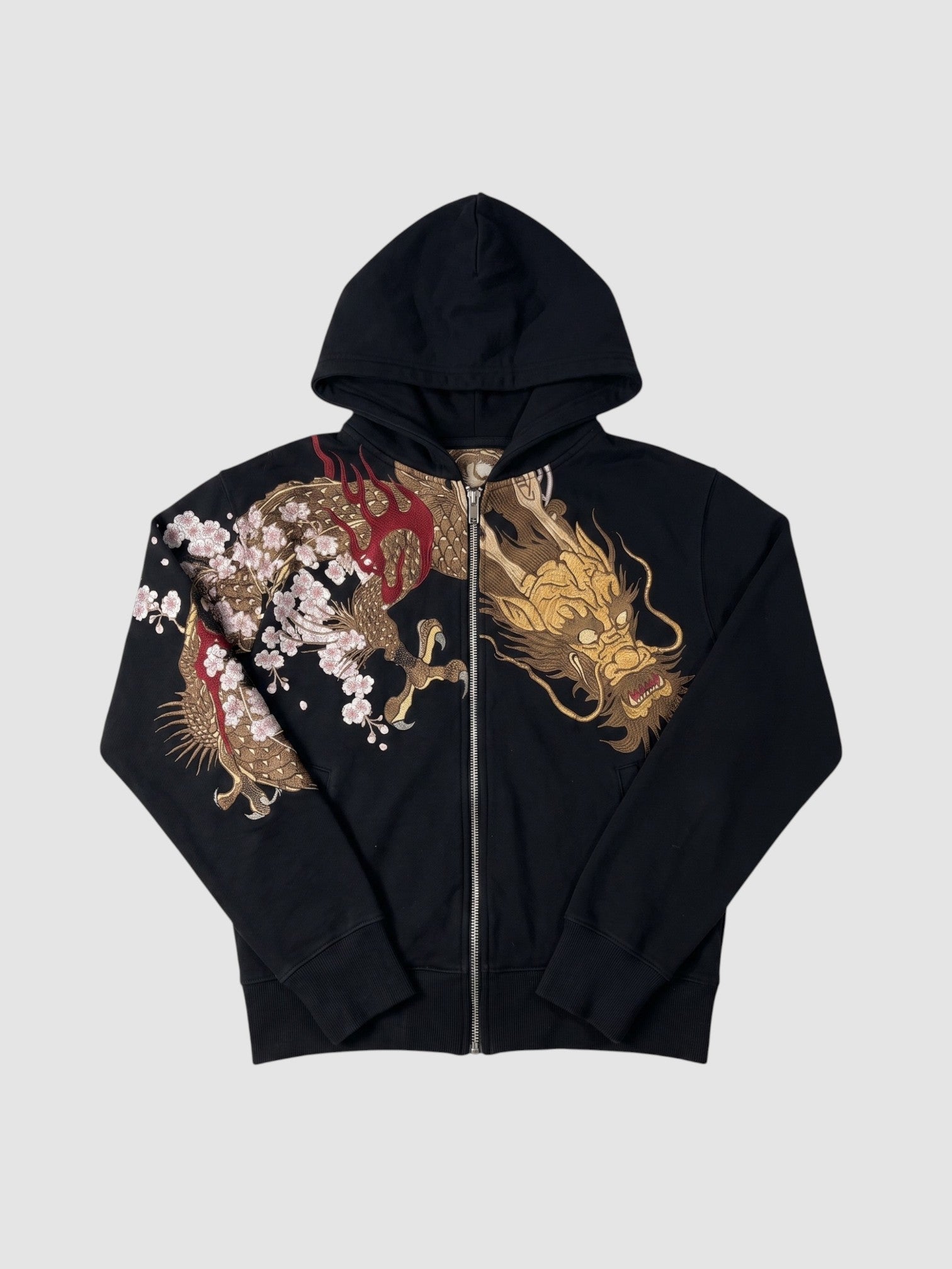 Y2K Studio black zip-up hoodie featuring a detailed gold dragon and cherry blossom print across the chest and sleeve.