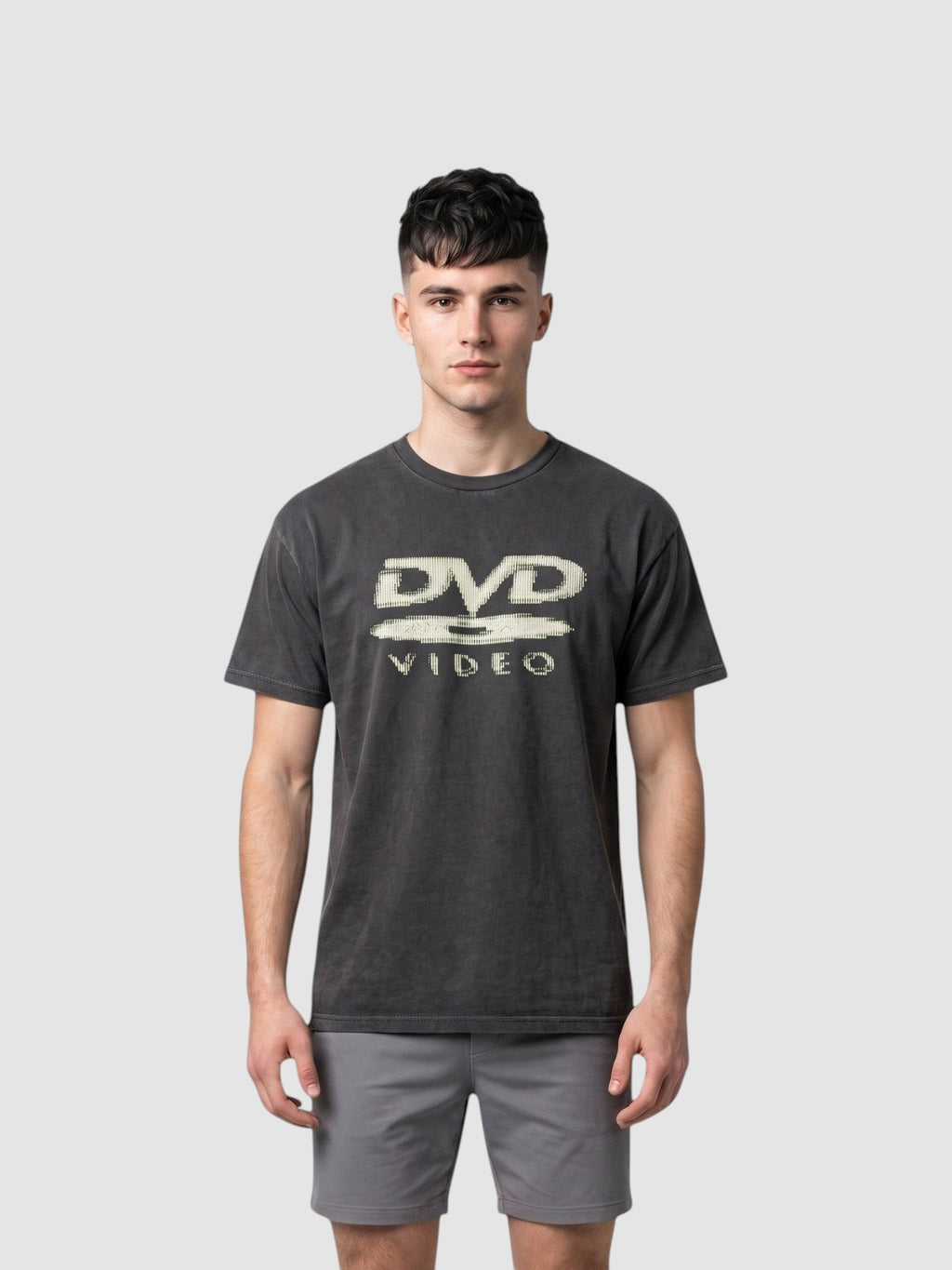 Y2K Studio black washed polyester t-shirt featuring an ecru DVD Video logo print on the chest worn by a male model