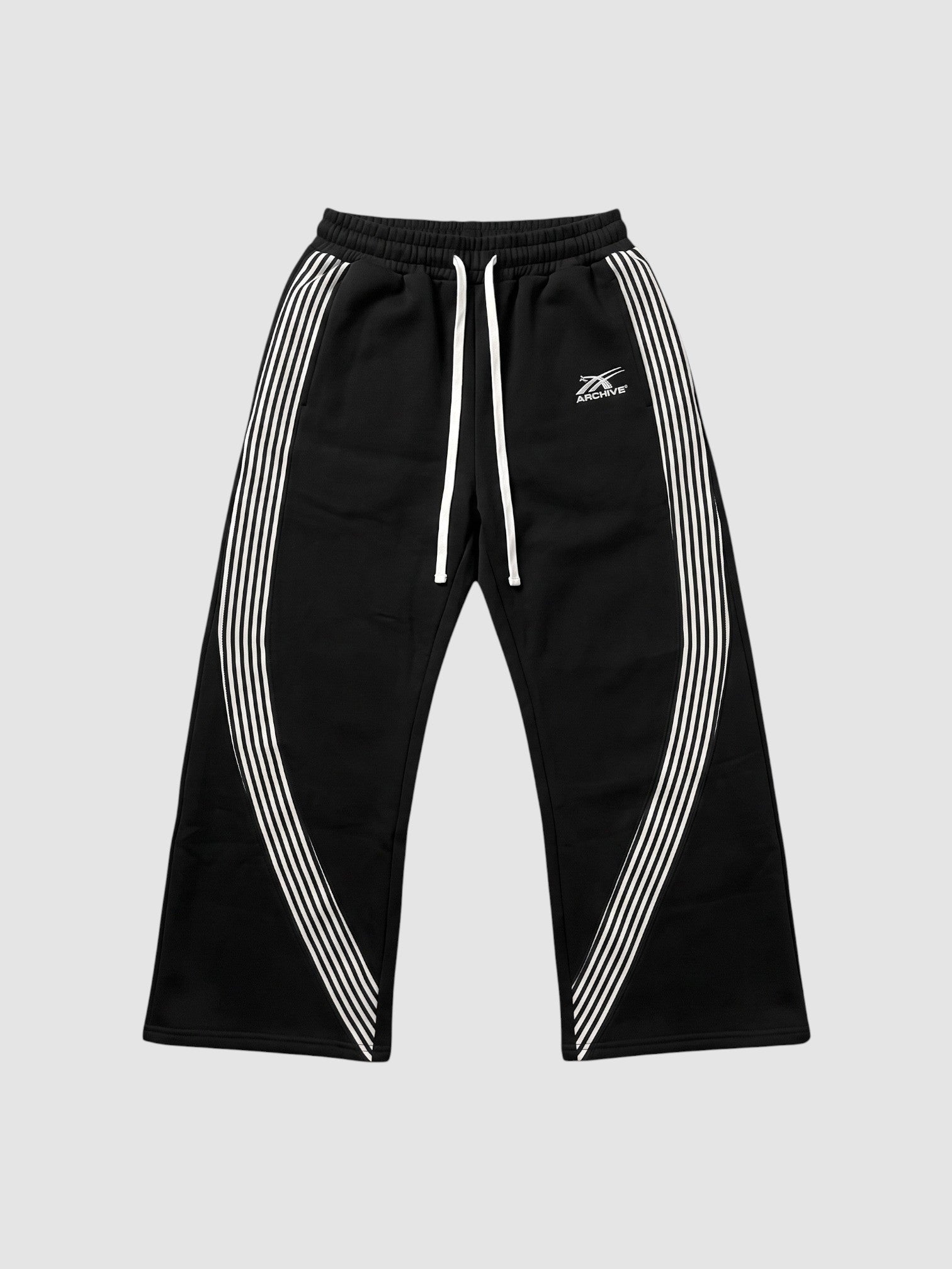 Y2K Studio black fleece baggy joggers with white side stripes and embroidered logo on the left thigh
