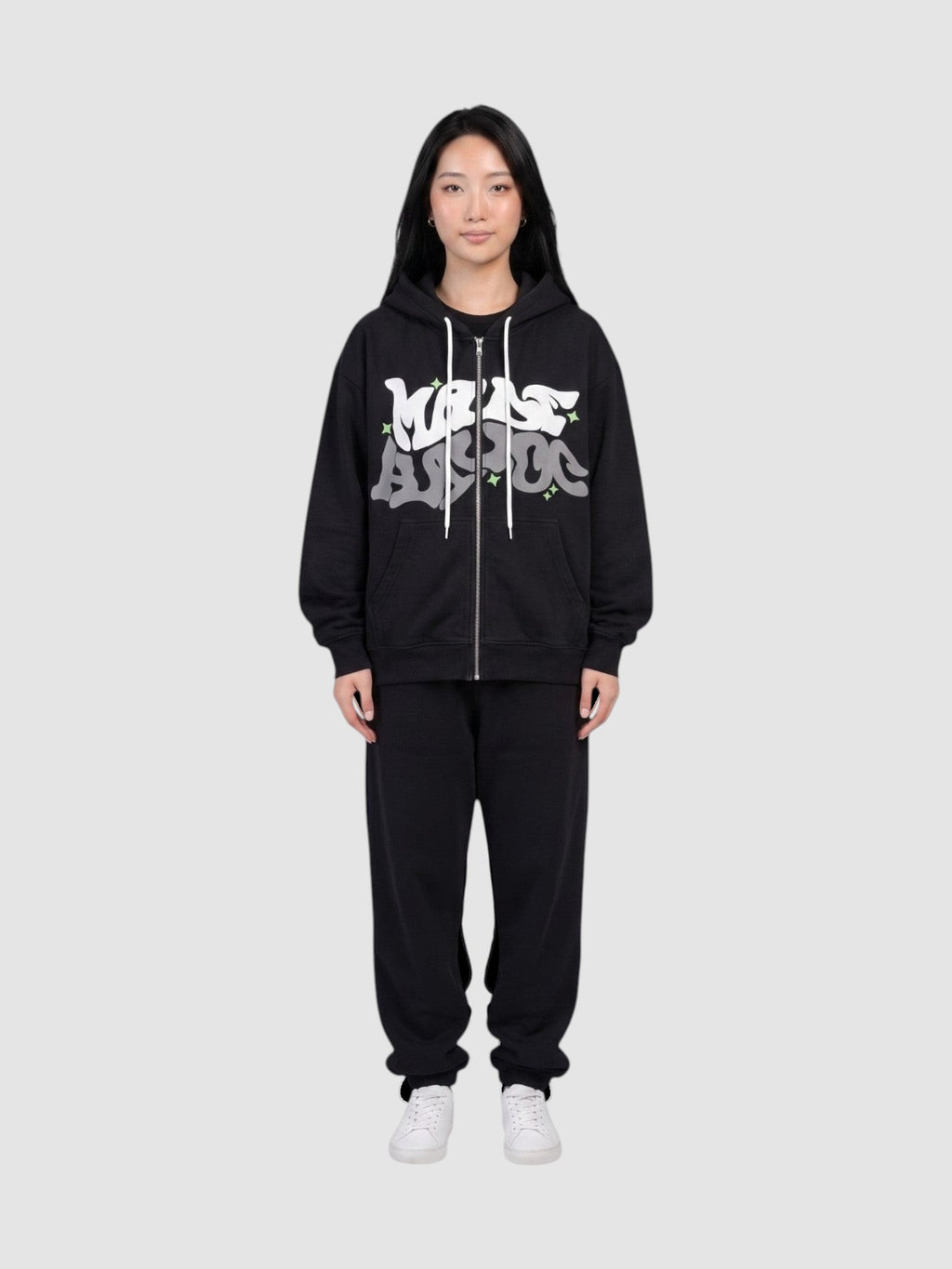 Y2K Studio black zip-up hoodie with white and grey graffiti bubble lettering and green star accents on a model