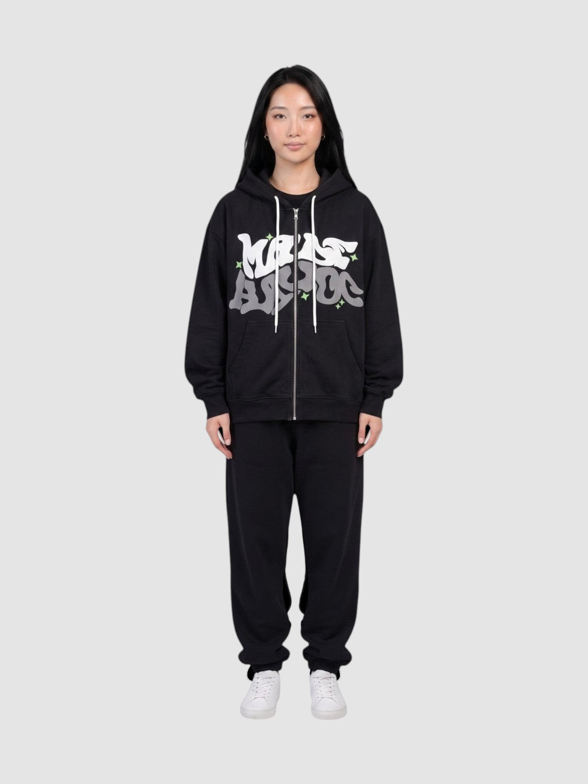 Y2K Studio black zip-up hoodie with white and grey graffiti bubble lettering and green star accents on a model
