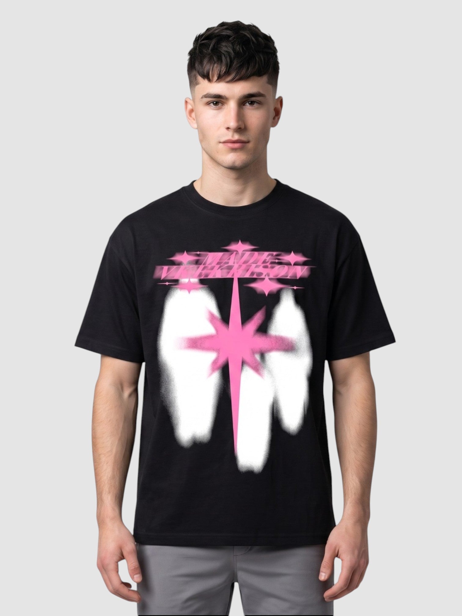 Y2K Studio black cotton t-shirt with a neon pink star and white silhouette graphic print worn by a male model