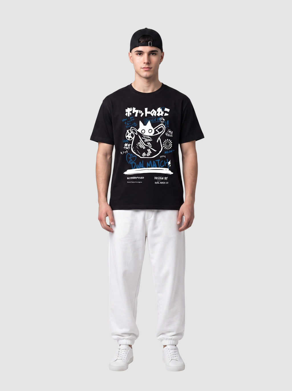 Y2K Studio black unisex t-shirt with white and blue Japanese cat graffiti print, worn by a man with white joggers