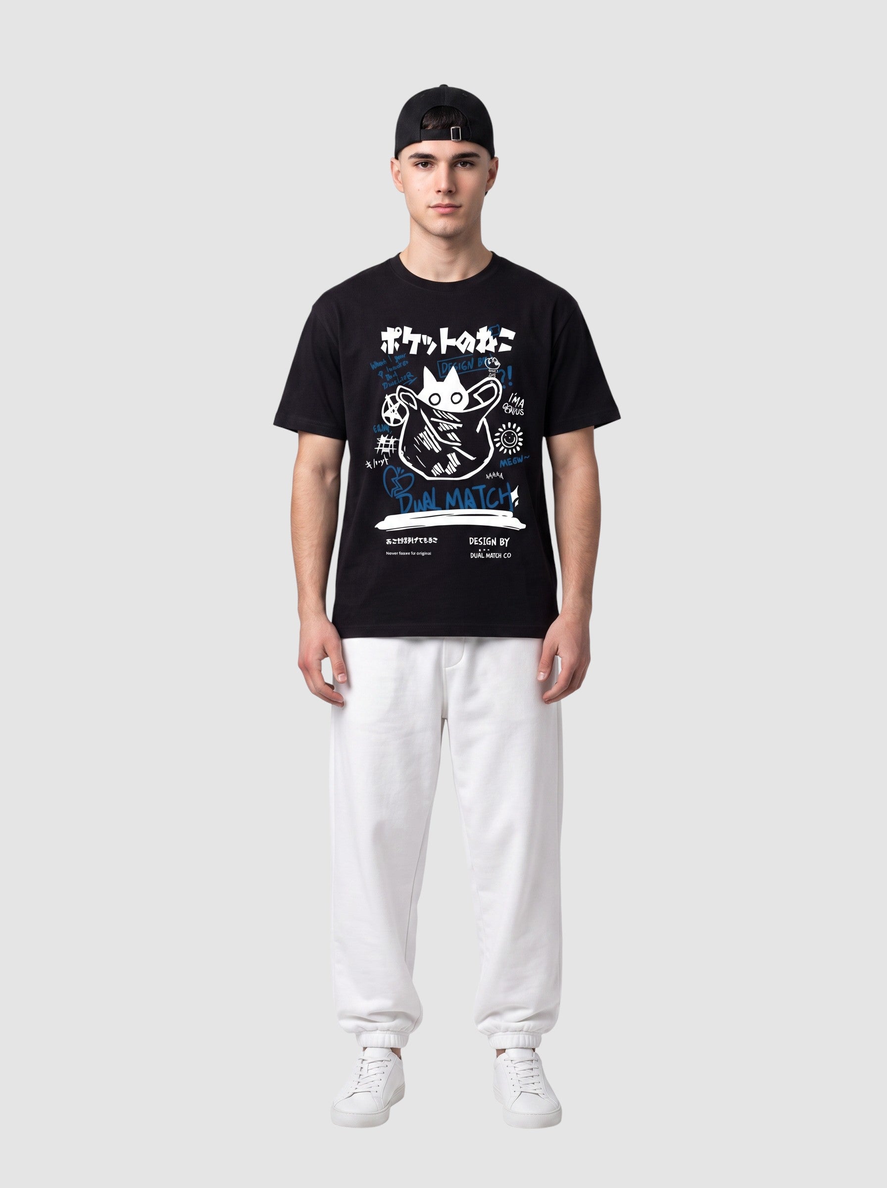 Y2K Studio black unisex t-shirt with white and blue Japanese cat graffiti print, worn by a man with white joggers