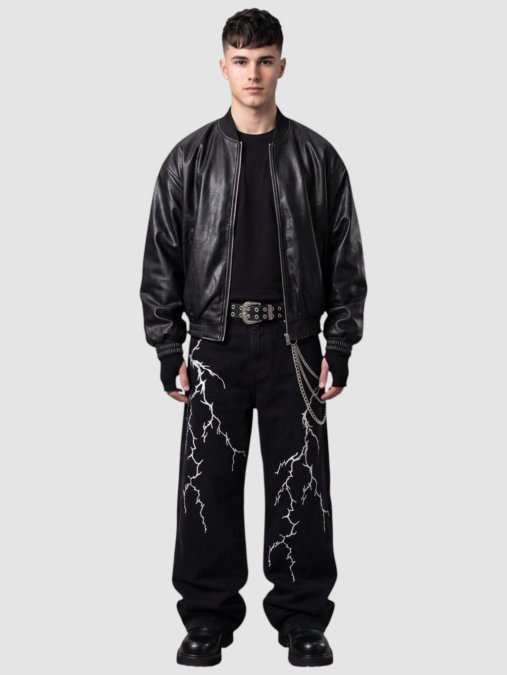 Y2K STUDIO black wide-leg denim jeans featuring white lightning embroidery, worn by a model with a leather jacket.