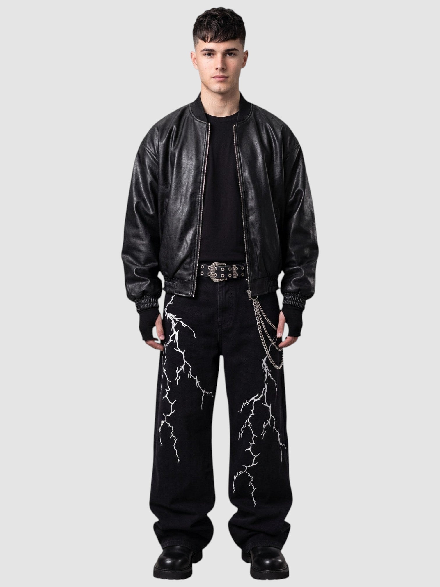 Y2K STUDIO black wide-leg denim jeans featuring white lightning embroidery, worn by a model with a leather jacket.