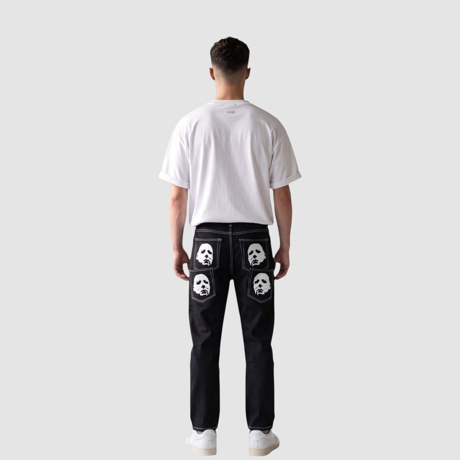 Y2K Studio black straight-leg denim jeans with white mask prints on back pockets and contrast white stitching