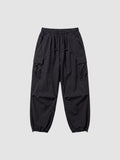 Y2K Studio black parachute cargo pants with a loose fit, elastic drawstring waist, and side flap pockets.