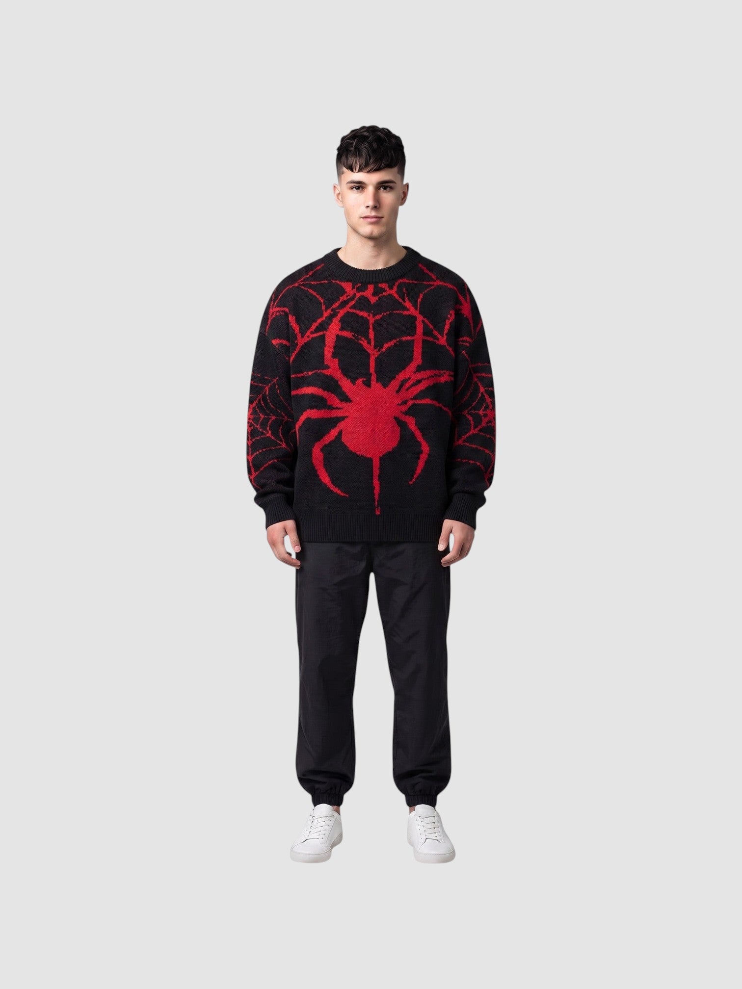Y2K STUDIO black and red oversized knit sweater with a large embroidered spider design worn by a male model
