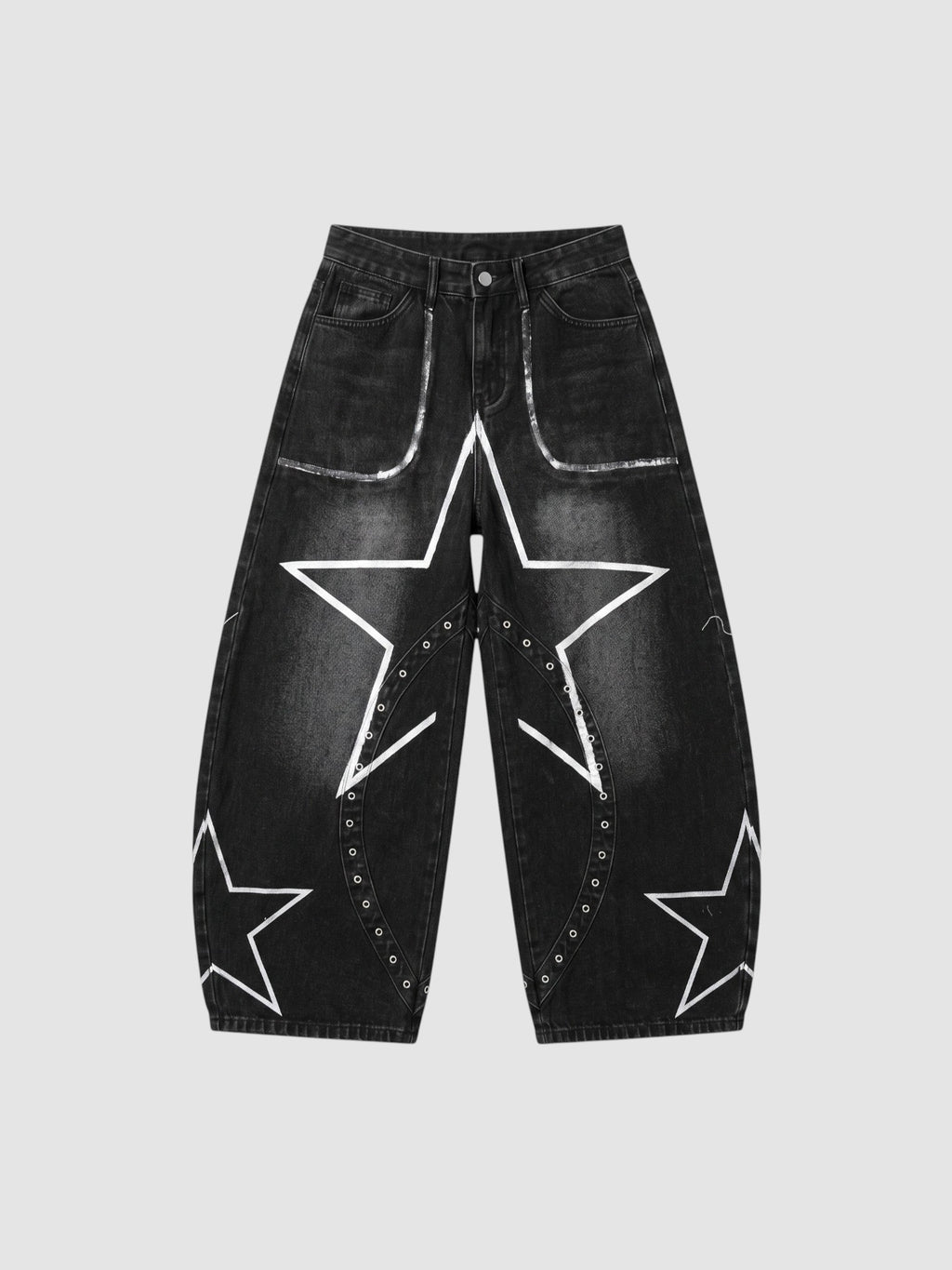 Y2K Studio black baggy jeans with white hand-drawn star patterns, low-rise waist, and metallic eyelet detailing.