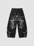 Y2K Studio black baggy jeans with white hand-drawn star patterns, low-rise waist, and metallic eyelet detailing.