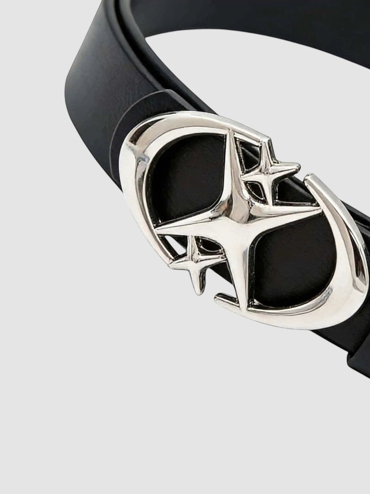 Y2K Studio black faux leather belt featuring a shiny silver star-shaped buckle with curved crescent blade details.