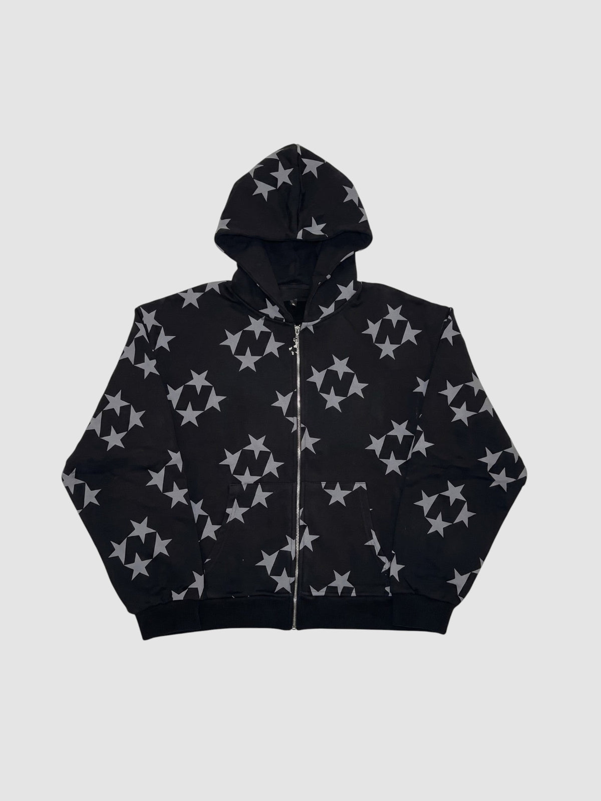 Y2K Studio black zip-up hoodie featuring an all-over grey star pattern, hood, and front pockets.