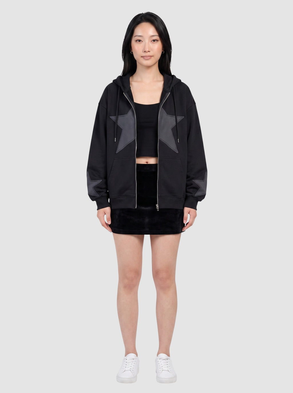 Y2K Studio black oversized zip-up hoodie featuring a large stitched star patch on the chest and smaller star cuffs.