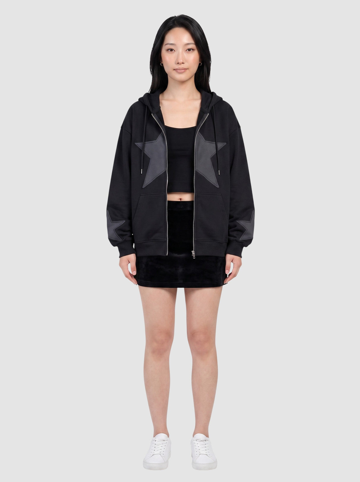 Y2K Studio black oversized zip-up hoodie featuring a large stitched star patch on the chest and smaller star cuffs.