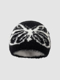 Y2K Studio black and white fuzzy beanie with a butterfly wing pattern in a soft, plush texture.
