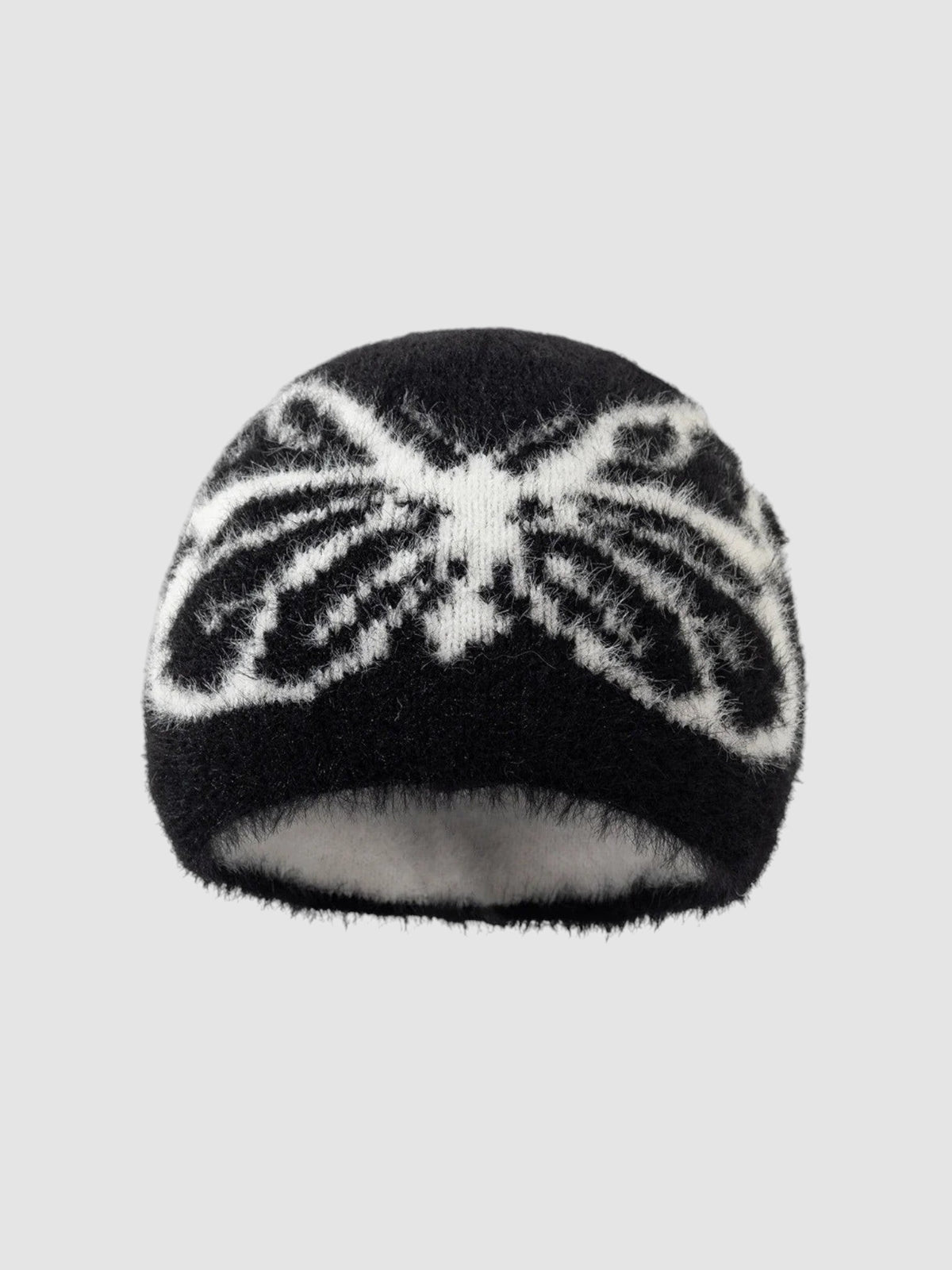 Y2K Studio black and white fuzzy beanie with a butterfly wing pattern in a soft, plush texture.