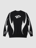 Y2K STUDIO black and white knit sweater featuring an abstract flame motif and a small embroidered chest logo.