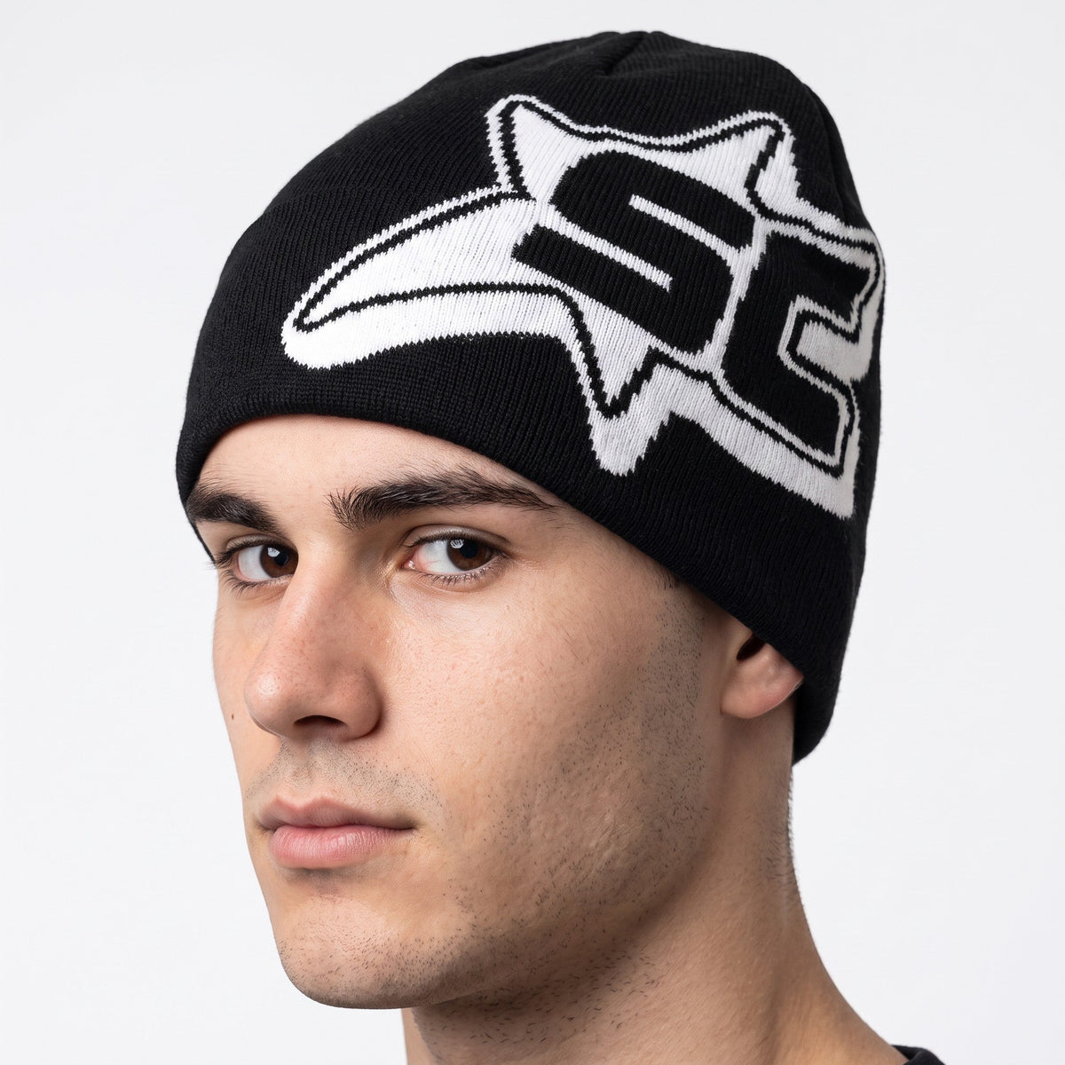 Y2K STUDIO black and white knit beanie with a bold star graphic print worn by a man for casual winter streetwear