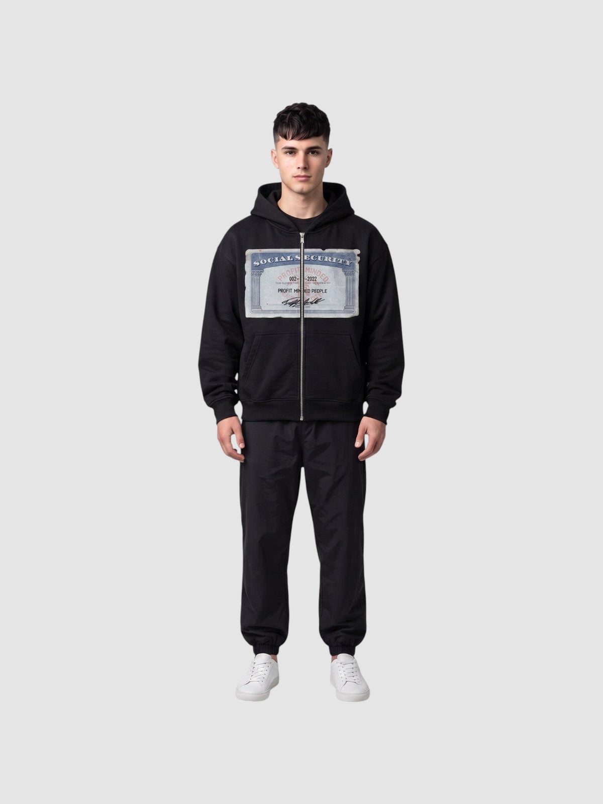 Y2K Studio black zip-up hoodie featuring a Social Security card graphic print on the chest, worn by a male model.