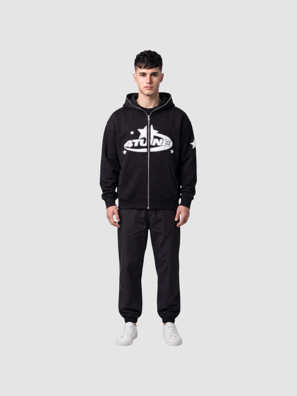 Y2K Studio black zip-up hoodie with white star lettering and fleece lining worn by a male model