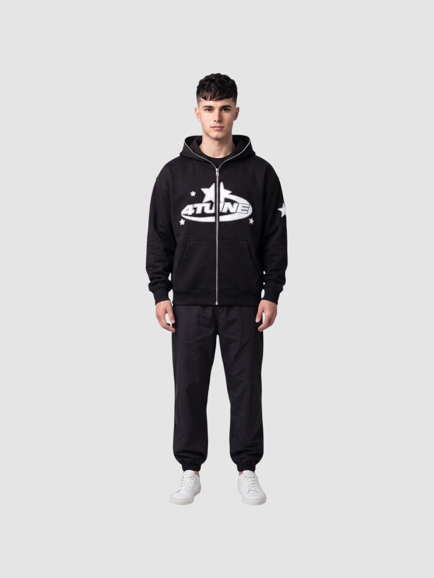 Y2K Studio black zip-up hoodie with white star lettering and fleece lining worn by a male model