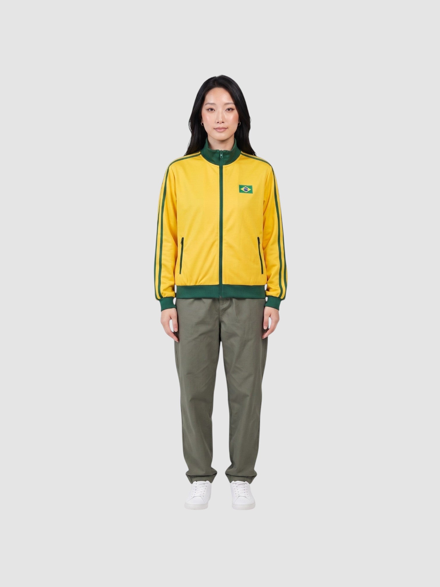 Y2K Studio yellow and green Brazil track jacket with a high collar, zip closure, and embroidered flag patch.