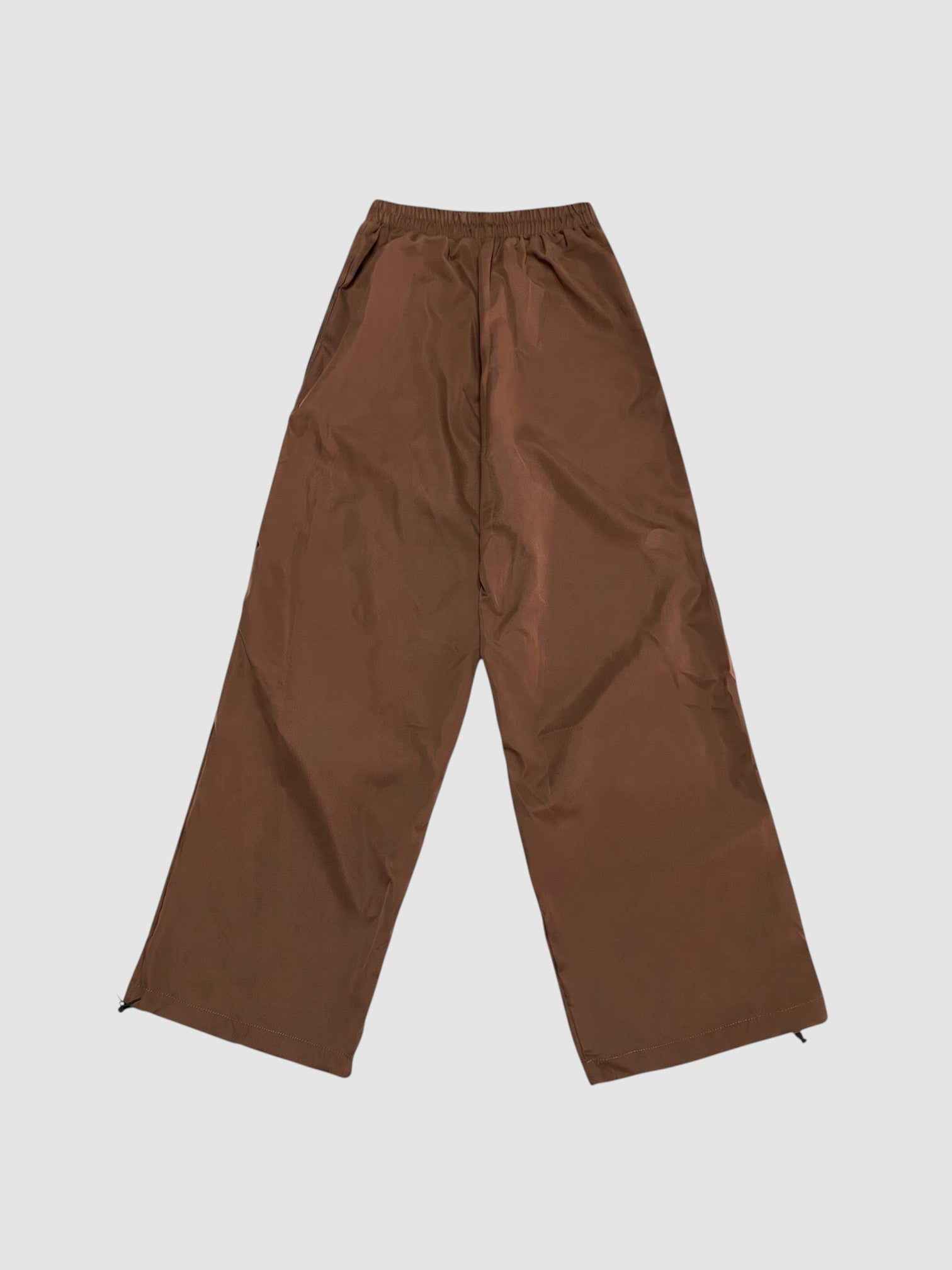 Y2K Studio brown nylon oversized joggers with high elastic waist and wide leg fit on a plain background