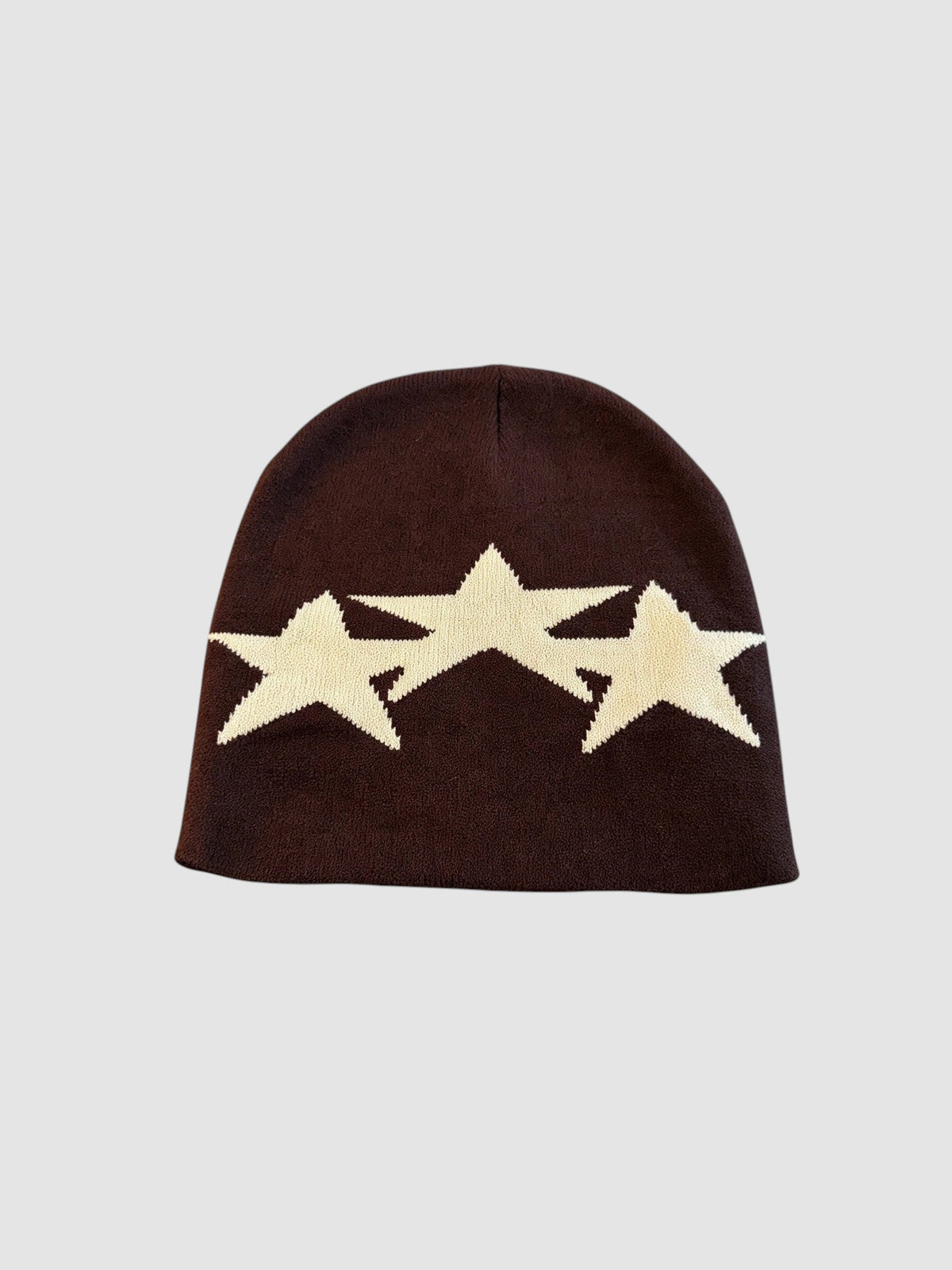 Y2K Studio Bonnet Étoile beanie in dark brown acrylic knit featuring three overlapping cream-colored star motifs.