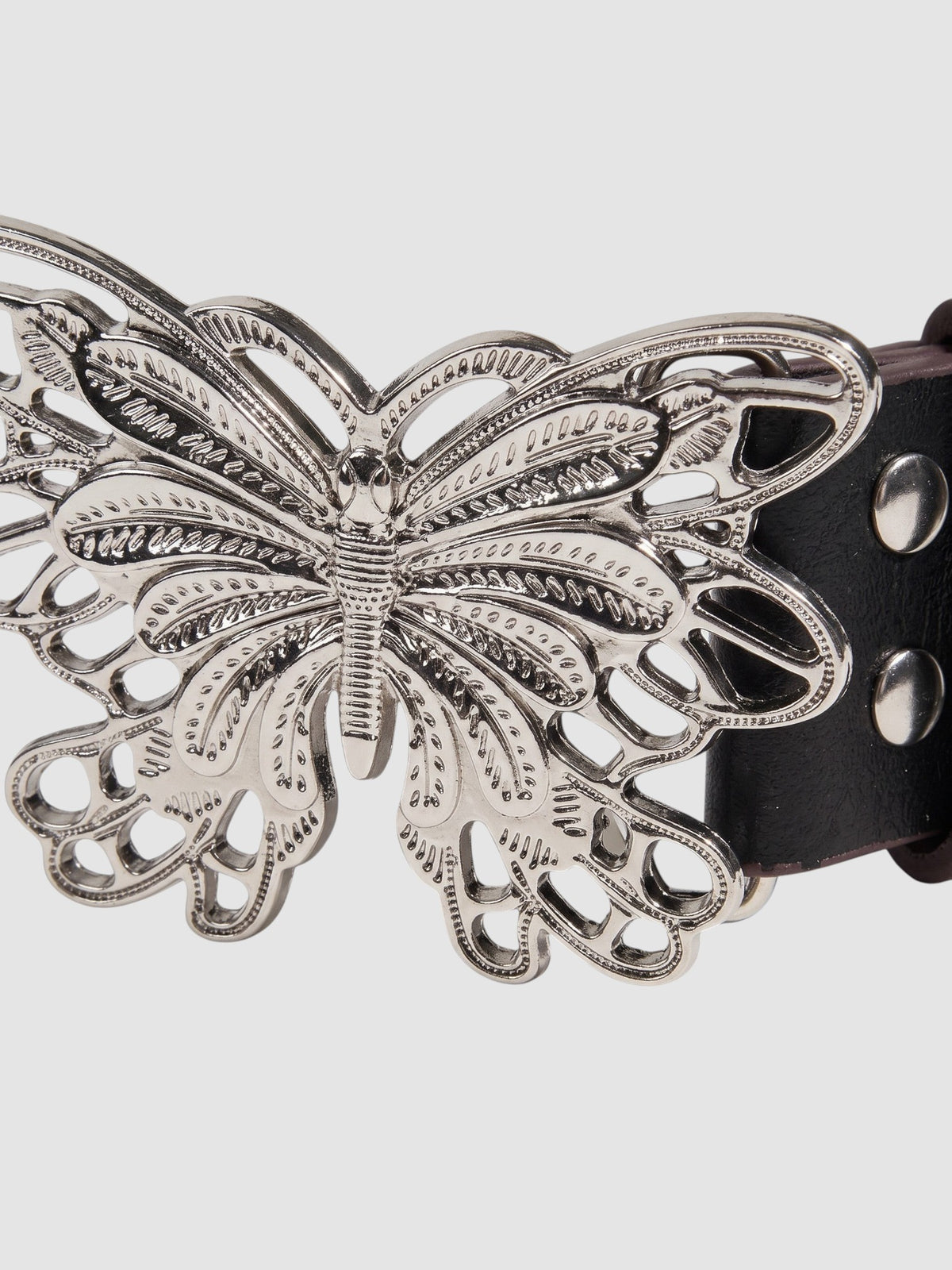 Y2K Studio black faux leather belt featuring a detailed silver filigree butterfly buckle and metal rivets.
