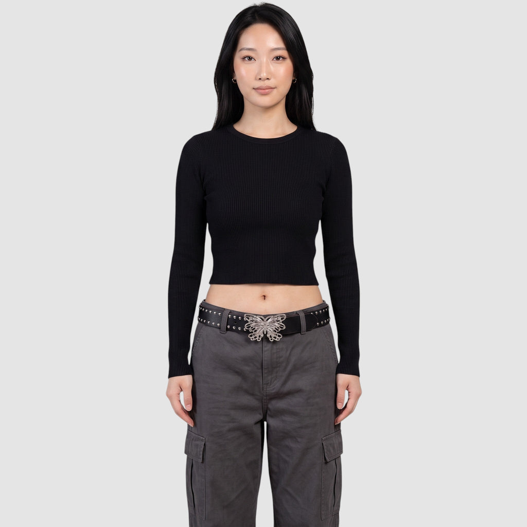 Y2K Studio black faux leather studded belt with a silver filigree butterfly buckle worn by a model in grey cargo pants