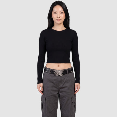 Y2K Studio black faux leather studded belt with a silver filigree butterfly buckle worn by a model in grey cargo pants