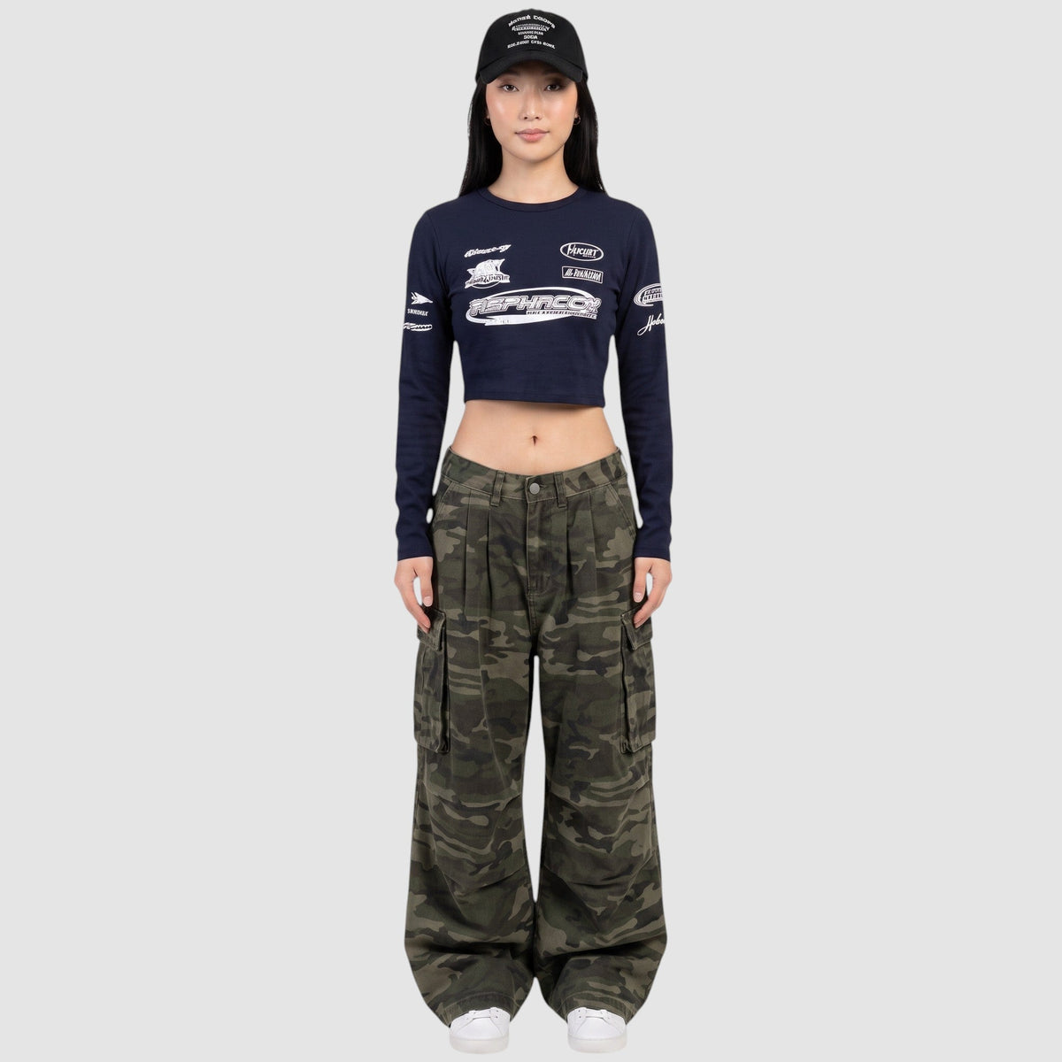 Y2K STUDIO high-waisted camouflage cargo pants with side pockets and wide-leg fit worn by a model