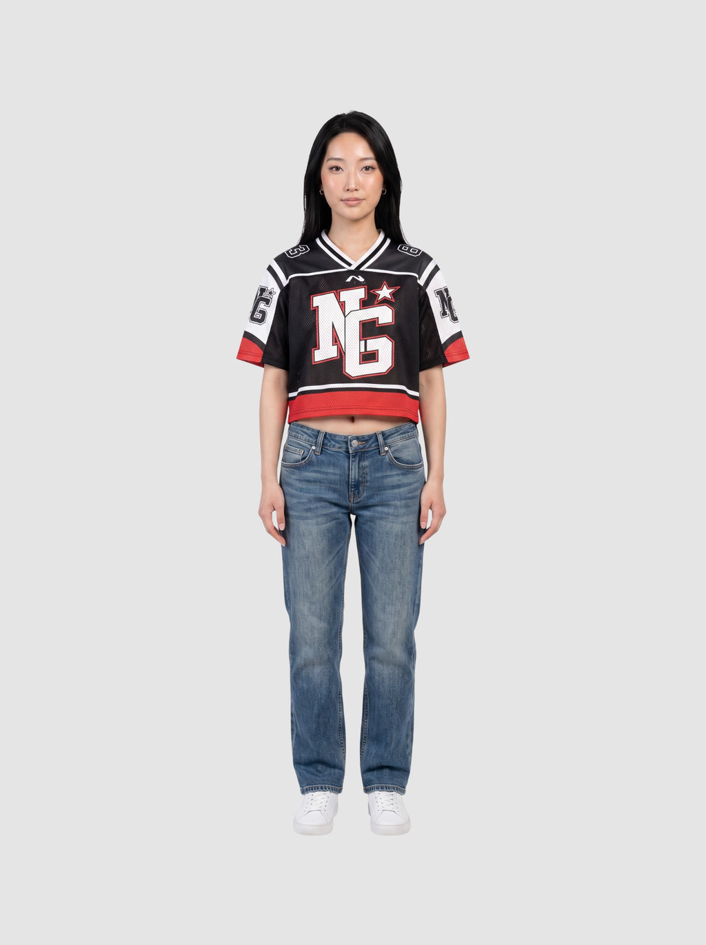 Y2K Studio cropped black mesh football jersey with white shoulder panels, red trim, and graphic monogram print.