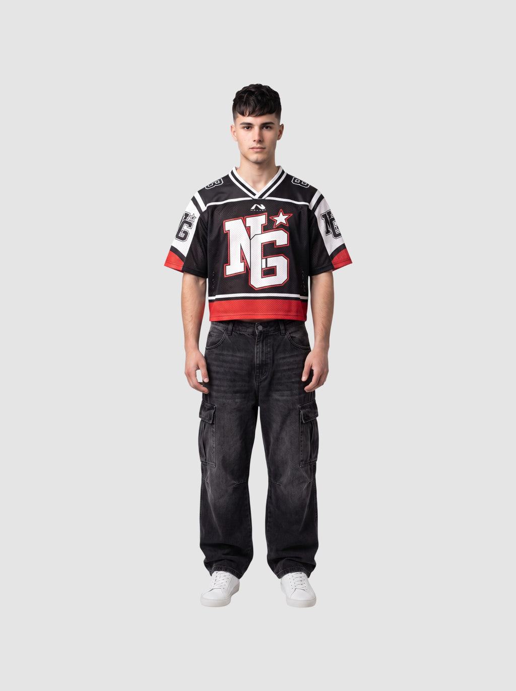 Y2K Studio cropped black mesh football jersey with white shoulder panels, red trim, and graphic monogram on chest.