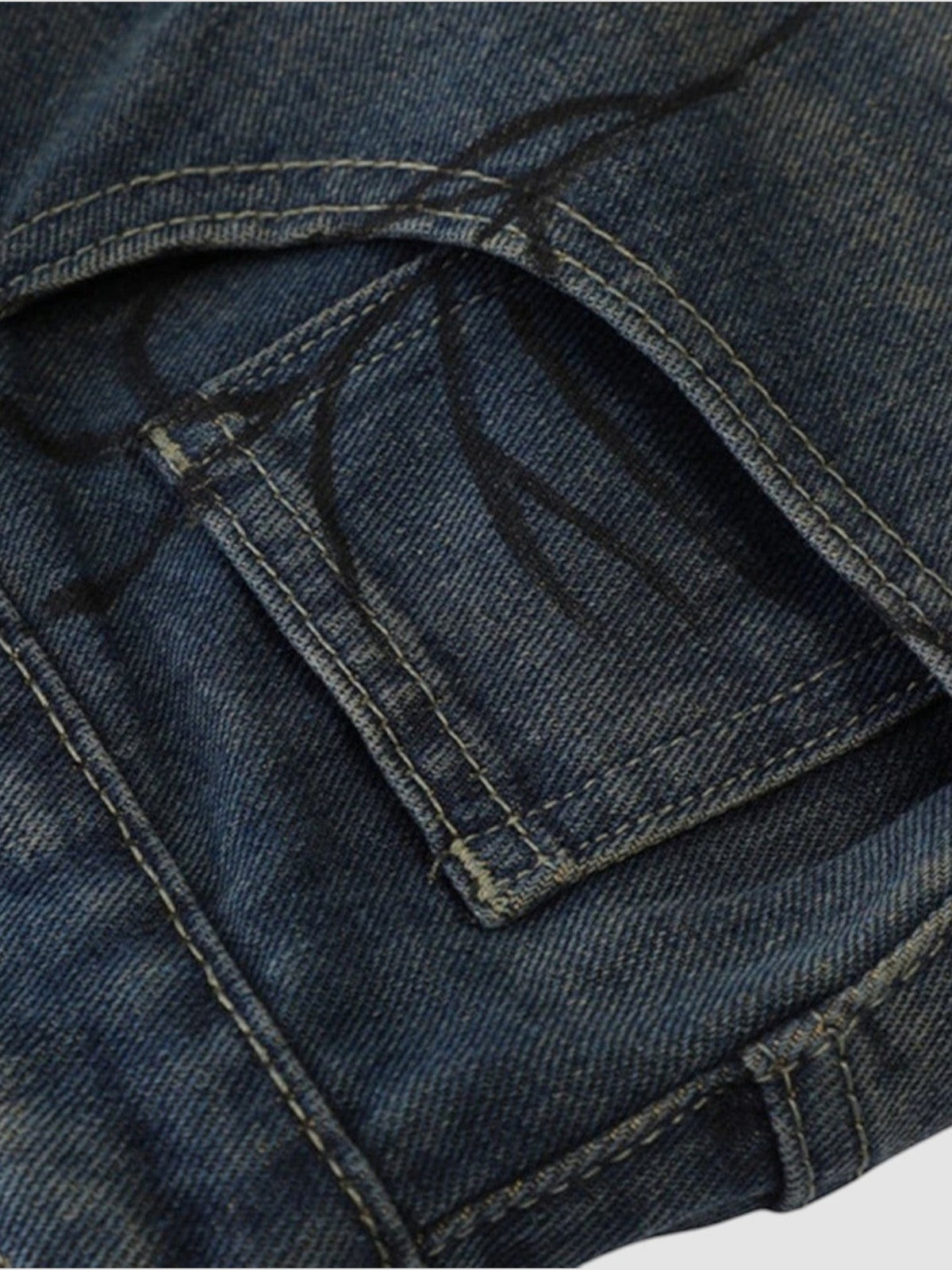 Y2K Studio Y2K spider print denim jorts in distressed blue cotton with detailed black spider graphic on pocket