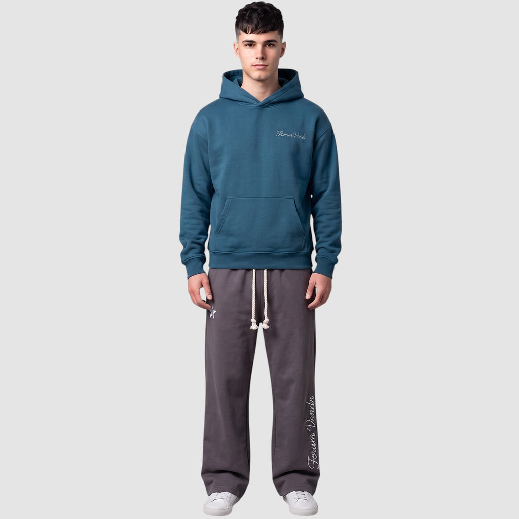 Y2K Studio double waist grey jogging pants with gothic embroidery and braided drawstring worn by a male model