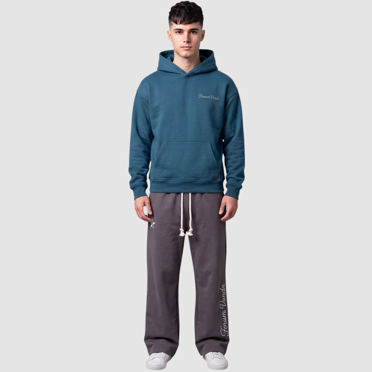 Y2K Studio double waist grey jogging pants with gothic embroidery and braided drawstring worn by a male model