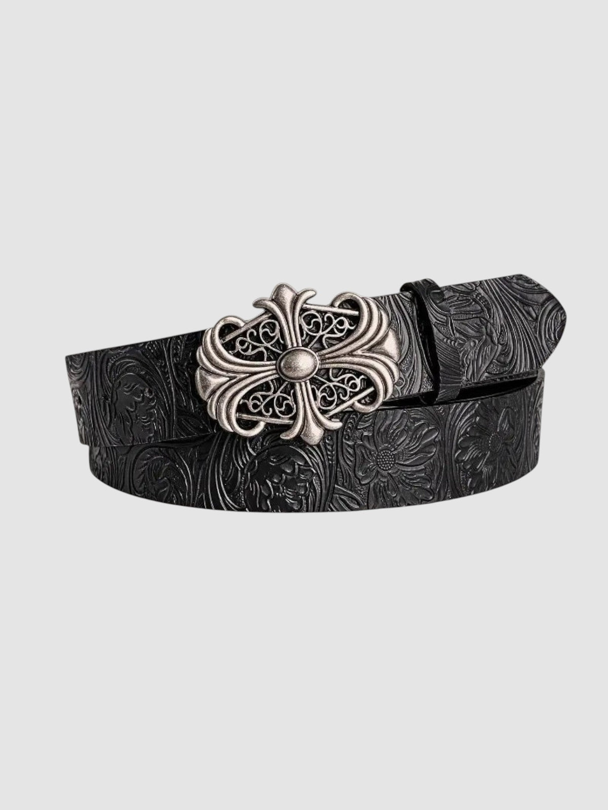 Y2K Studio black faux leather belt with floral tooling and an ornate silver cross buckle in a gothic rock style.
