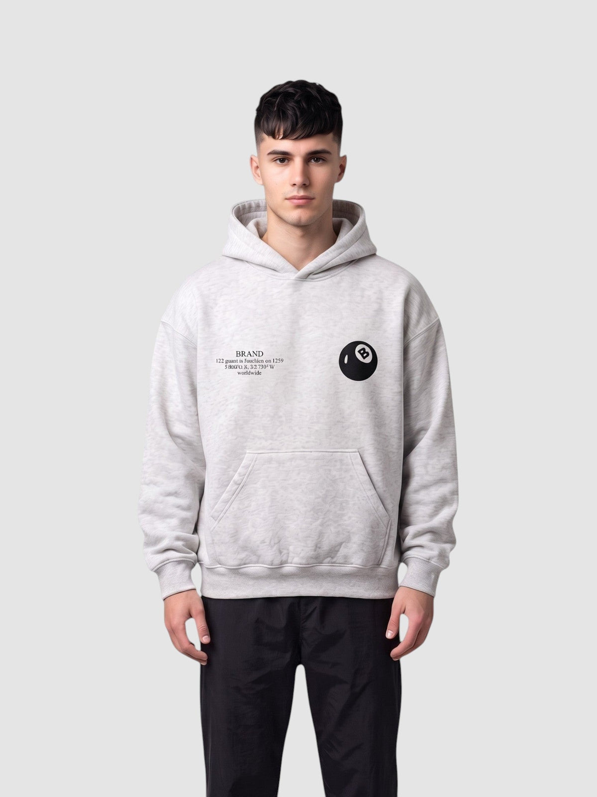 Y2K Studio grey heathered boxy hoodie with 8-ball chest logo and kangaroo pocket worn by a male model