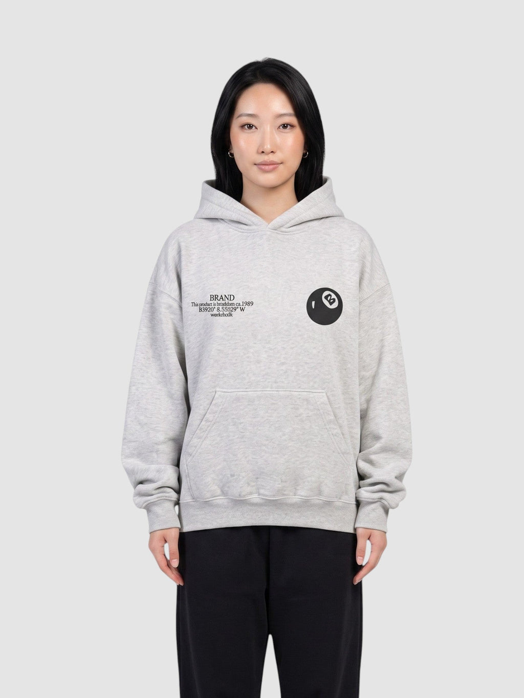Y2K Studio grey oversized hoodie with 8 ball logo and chest text, worn by a model against a neutral background.